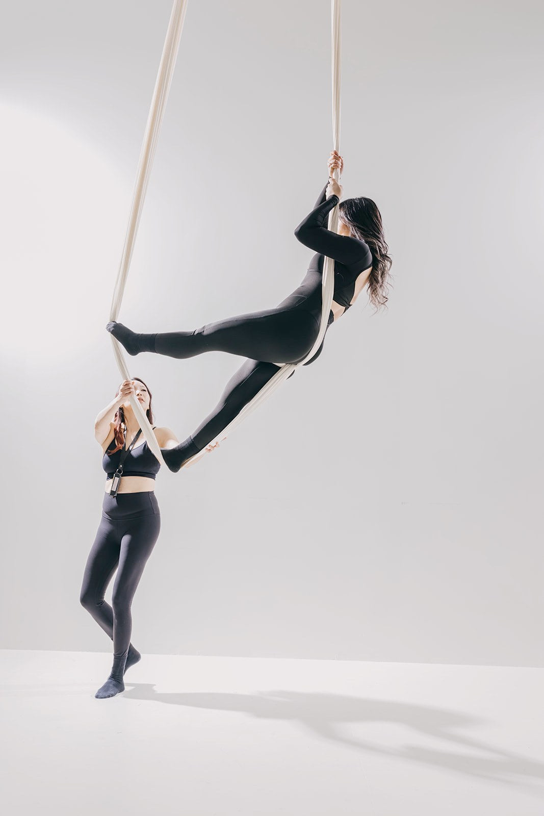 Everose instructor spotting a dancer in a light-set pose