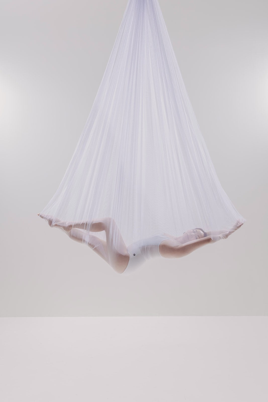 Dancer in sheer white mesh on the light set
