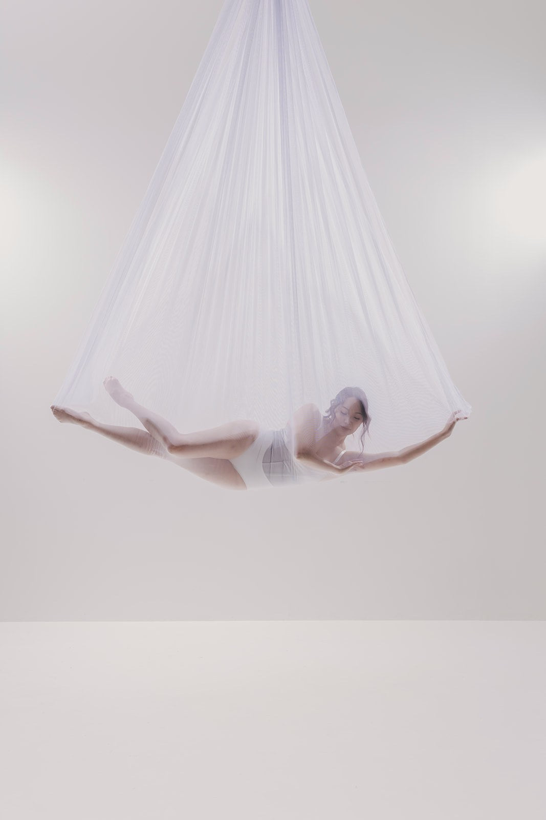 Dancer in sheer white mesh on the light set