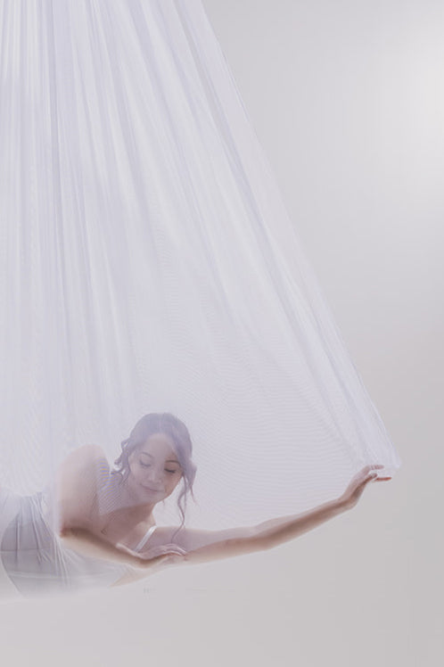 Close-up of a dancer in sheer white silk with soft makeup